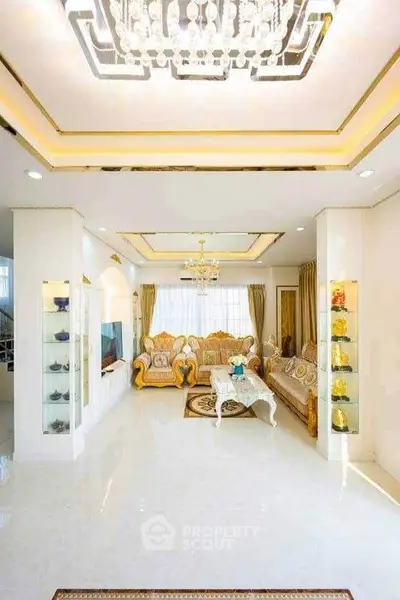 Luxurious living room with elegant chandelier and plush seating in a bright, spacious interior.