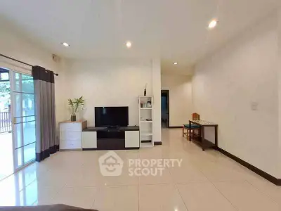 Spacious living room with modern decor and large windows for natural light.