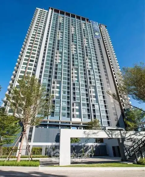 Stunning high-rise building with modern architecture and lush greenery, perfect for urban living.