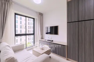 Modern living room with large window and sleek furniture in urban apartment