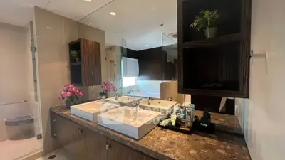 Luxurious bathroom with dual sinks and elegant decor in modern real estate property.