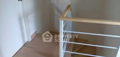 Minimalist staircase with wooden steps and white railing in modern home
