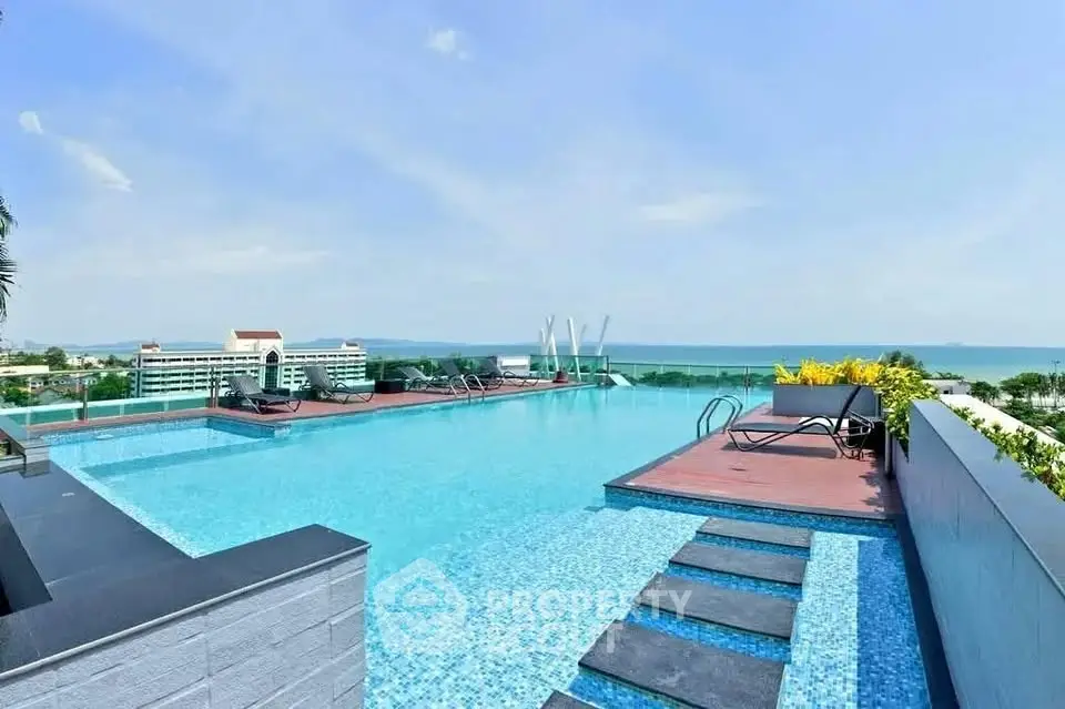Luxurious rooftop infinity pool with stunning ocean view and modern lounge area.