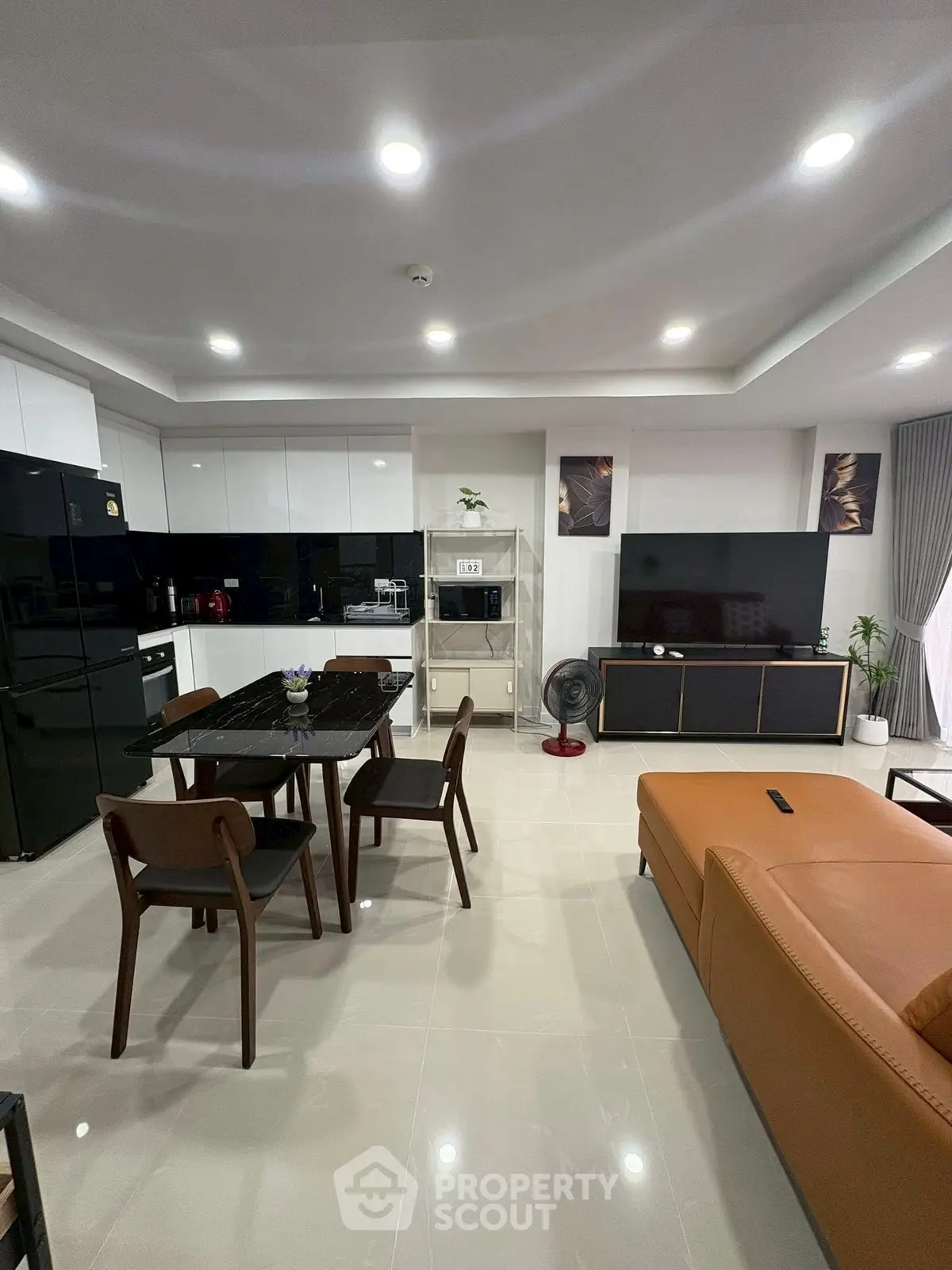 Modern open-layout living room with sleek kitchen and stylish furniture