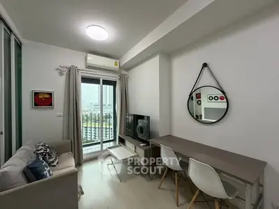 Modern living room with city view, stylish decor, and cozy ambiance in a high-rise apartment.