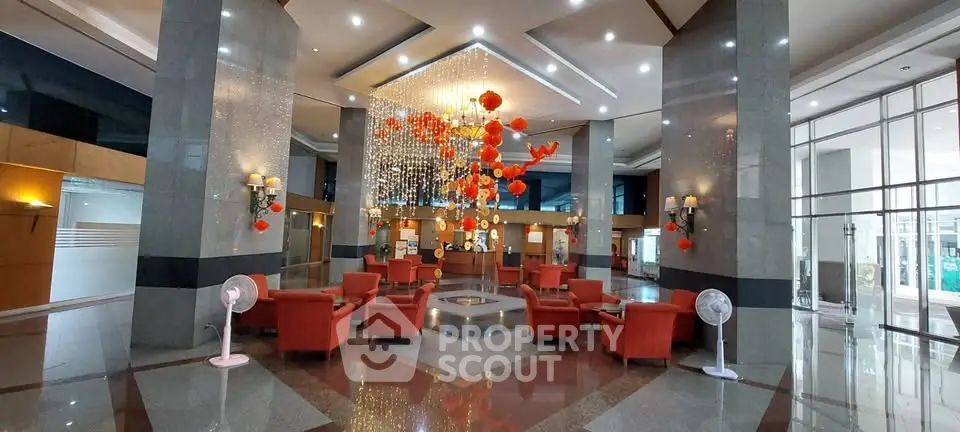 Luxurious building lobby with elegant decor and plush seating, perfect for welcoming guests.