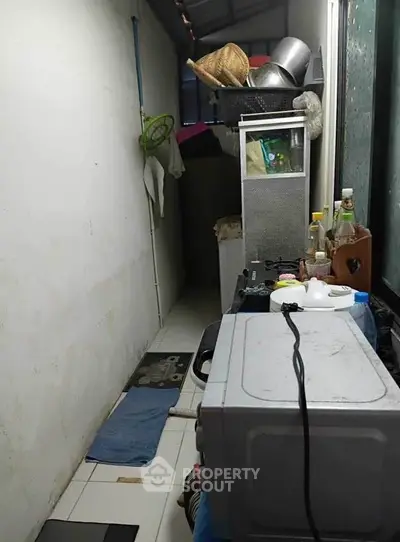 Compact storage area with household items and appliances