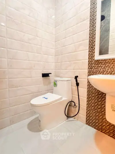 Modern bathroom with sleek white tiles and contemporary fixtures