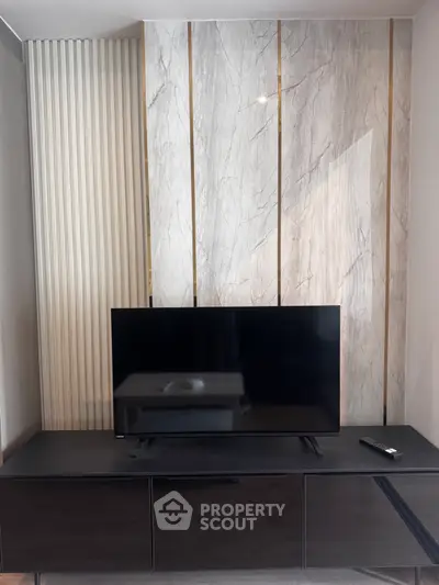 Modern living room with sleek TV stand and elegant marble accent wall