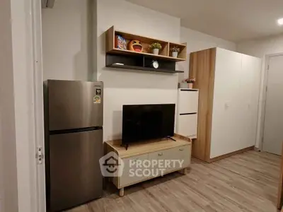 Modern living room with sleek fridge, TV, and stylish storage solutions.