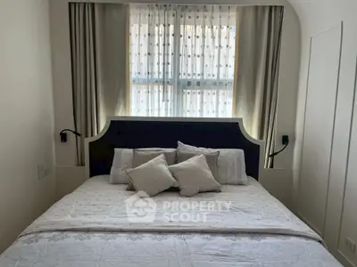 Cozy bedroom with elegant bed and stylish curtains, perfect for restful nights.