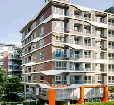 Modern multi-story apartment building with unique architectural design and vibrant exterior colors.