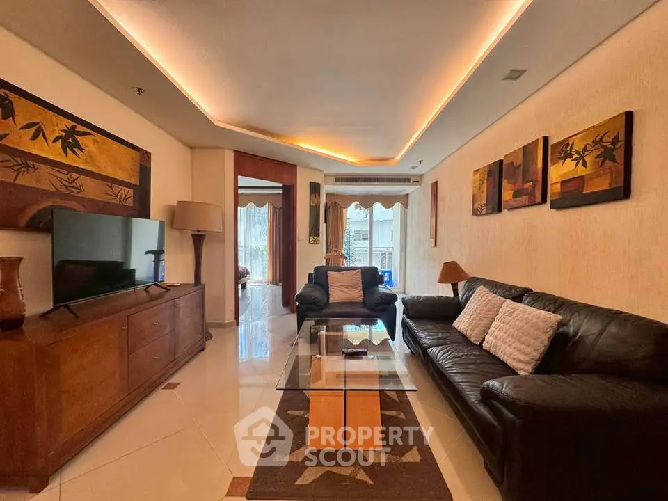 Luxurious living room with modern decor and ambient lighting, featuring elegant furniture and a stylish glass coffee table.