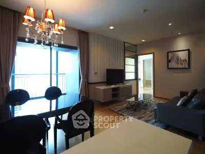 Modern living room with elegant chandelier and balcony view