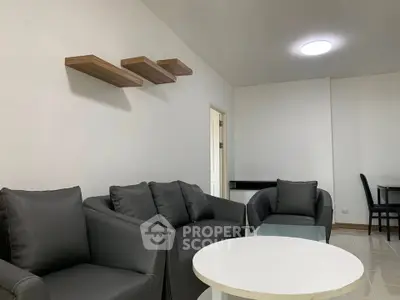 Modern living room with sleek black sofas and minimalist decor