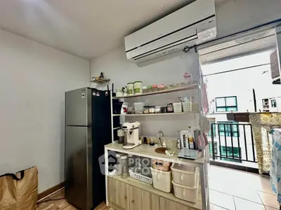 Modern kitchen with open shelving and balcony view