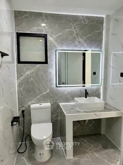 Modern bathroom with elegant marble tiles and sleek fixtures