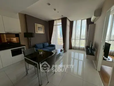 Modern living room with sleek furniture and large windows offering city views.