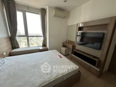 Modern bedroom with large window and city view, featuring a wall-mounted TV and stylish wooden furniture.