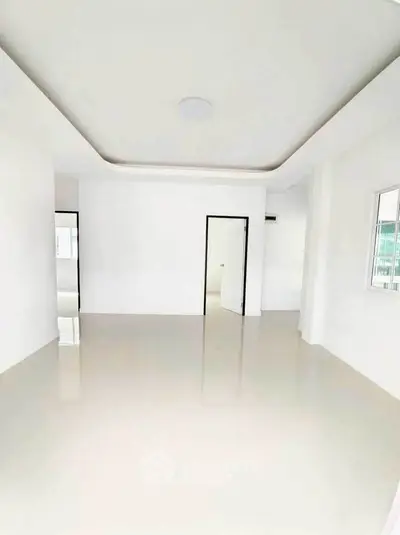 Spacious empty room with glossy floors and modern white walls, perfect for customization.