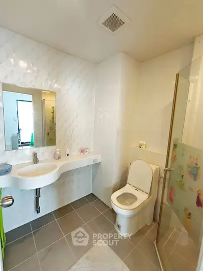 Modern bathroom with sleek fixtures and glass shower enclosure