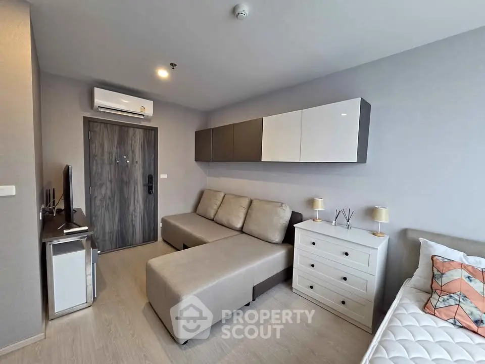 Modern living room with stylish furniture and neutral tones in a cozy apartment setting.