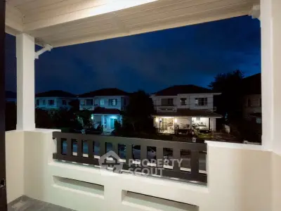 Charming balcony view of suburban homes at dusk, perfect for relaxing evenings.