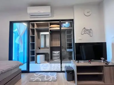 Modern bedroom with sliding glass wardrobe and TV unit, featuring stylish decor and ample storage space.