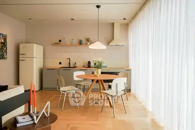 Modern kitchen with sleek design, featuring open layout and stylish dining area.