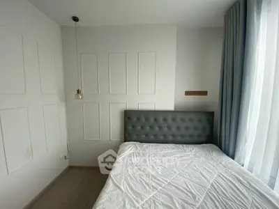 Modern minimalist bedroom with tufted headboard and natural light