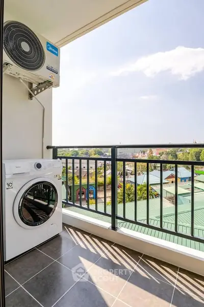 Modern balcony with washing machine and scenic view, perfect for urban living.