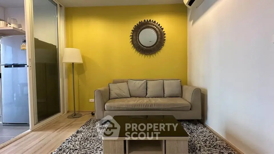 Modern living room with yellow accent wall, cozy sofa, and stylish decor