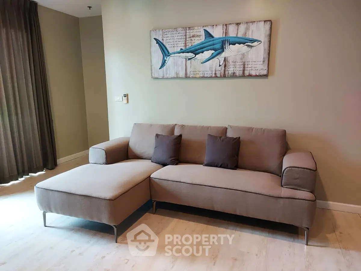 Modern living room with stylish sofa and shark artwork, perfect for contemporary home decor.