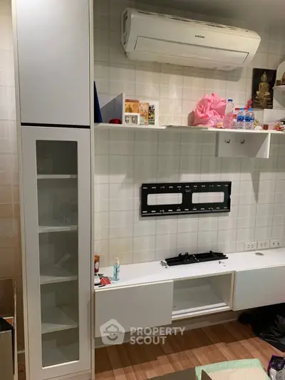 Sleek modern kitchen with built-in gas stove and ample storage, featuring clean white cabinetry and stylish backsplash tiles.