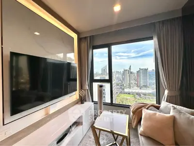Modern living room with large TV and stunning city view through window.