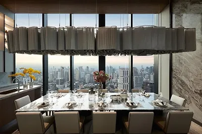 Luxurious dining room with panoramic city view and elegant chandelier