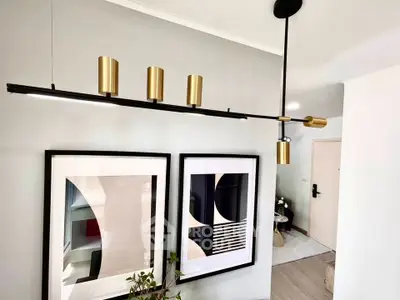 Modern interior with stylish lighting and abstract art in a contemporary living space.