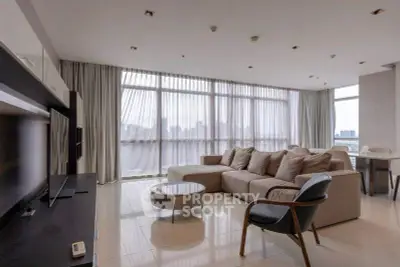 Spacious modern living room with large windows and city view, featuring elegant furniture and natural light.