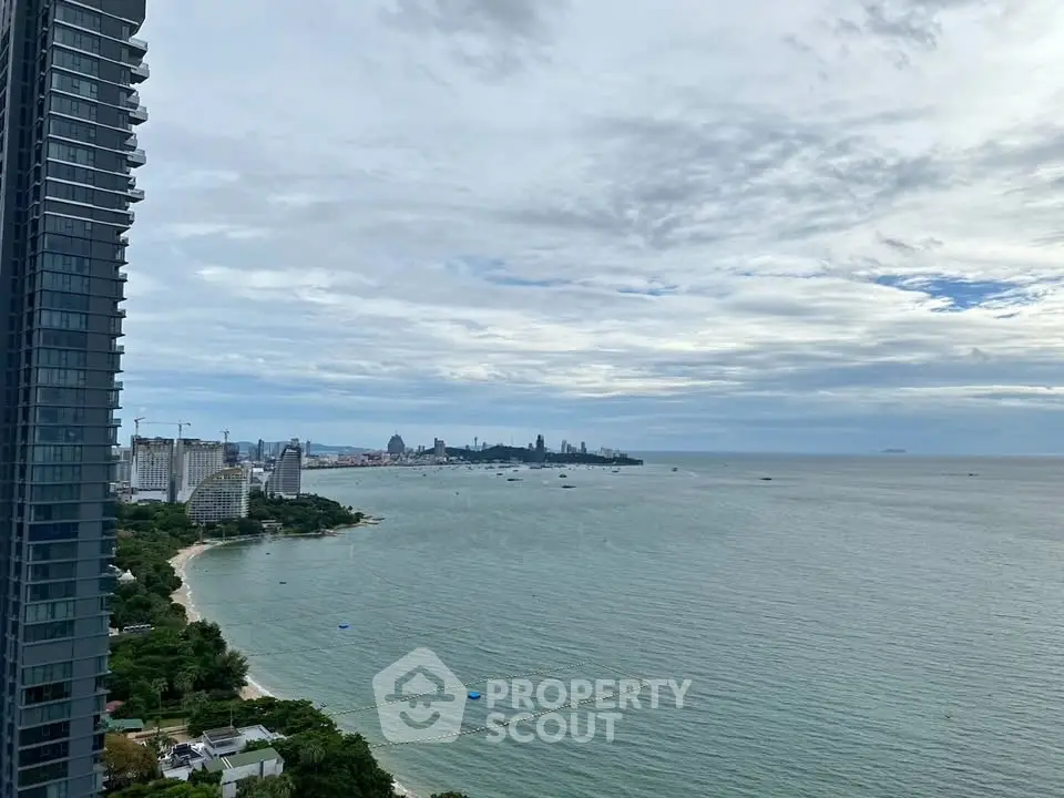 Stunning ocean view from high-rise building overlooking city skyline and coastline.