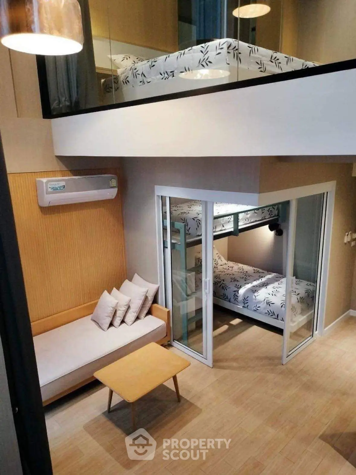 Modern loft-style apartment with mezzanine and cozy living area.