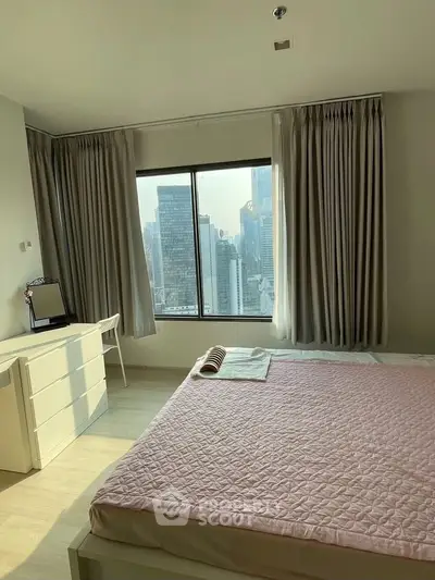 Spacious bedroom with city view, featuring large window and modern furnishings.