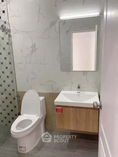 Modern bathroom with sleek fixtures and elegant tile design, perfect for a contemporary home.