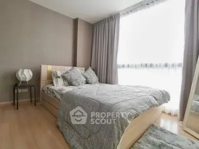 Cozy bedroom with large window and modern decor