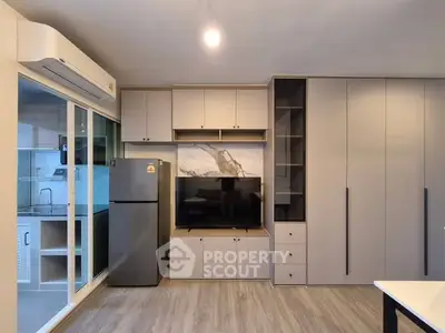 Modern living room with built-in storage and sleek kitchen appliances