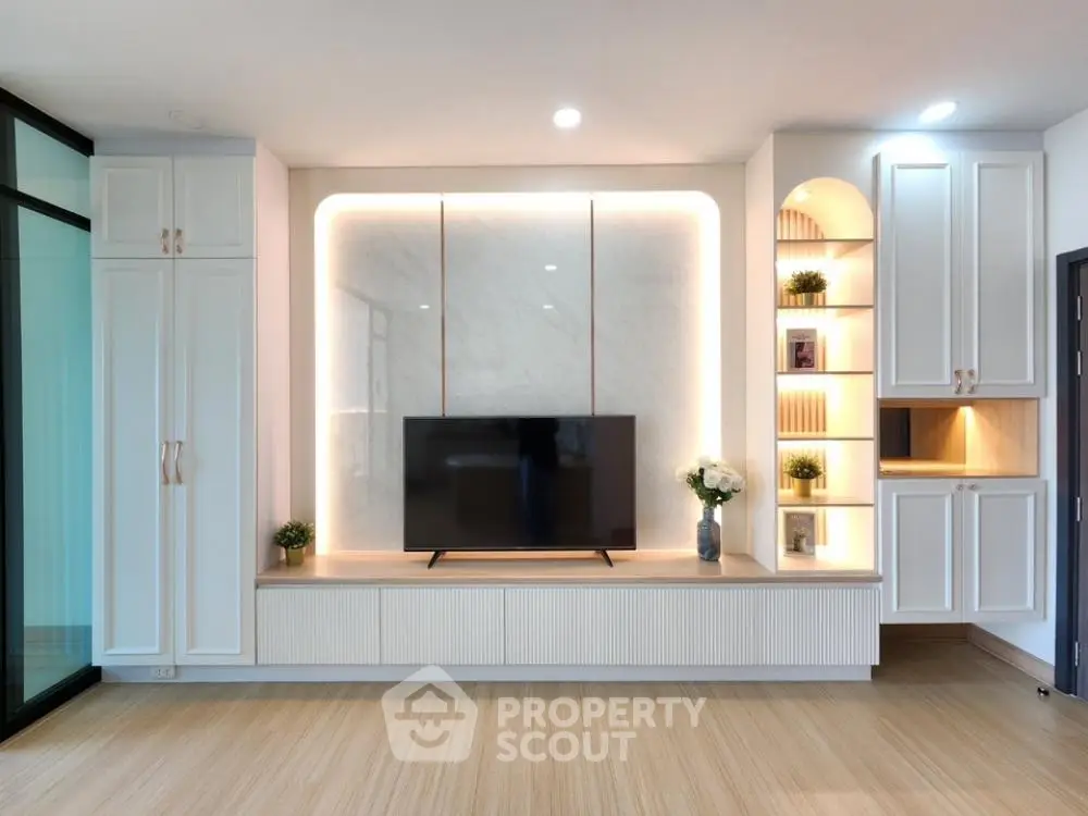 Modern living room with elegant built-in TV unit and ambient lighting