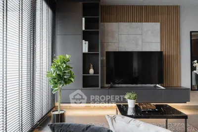 Chic modern living room with sleek design, featuring a large flat-screen TV, elegant furniture, and tasteful decor, perfect for urban living.