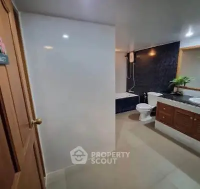 Spacious modern bathroom with bathtub and elegant fixtures