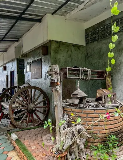 Charming rustic exterior with vintage well and wagon wheel decor