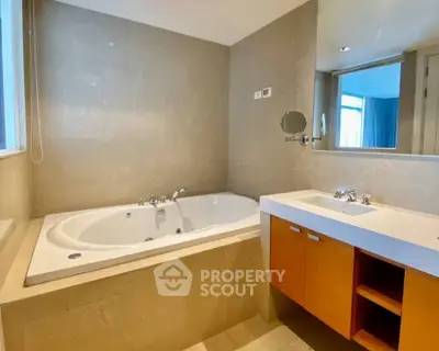 Luxurious bathroom with elegant bathtub and modern vanity in a stylish home.