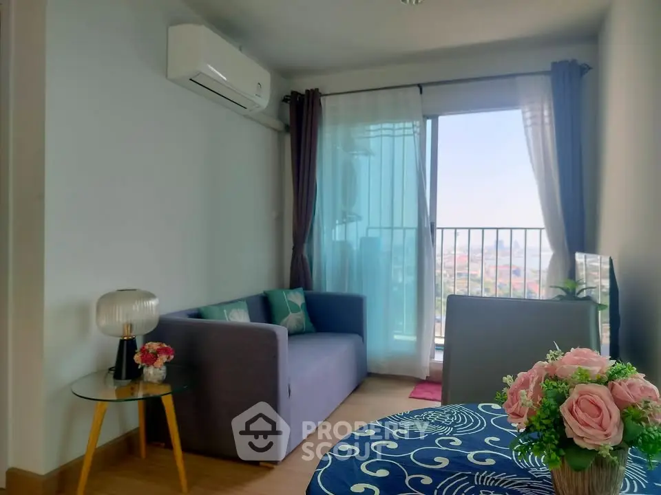 Charming living room with balcony view, modern sofa, and stylish decor in a cozy apartment.